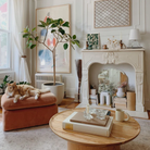 The Nicole Rechargeable LED Table Lamp from Mitzi in a lounge surrounded by other decor and furniture.