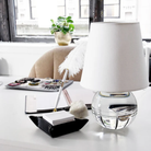 The Nicole Rechargeable LED Table Lamp from Mitzi on top of a table in an office.
