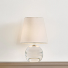 The Nicole Rechargeable LED Table Lamp from Mitzi in a studio on top of a surface.