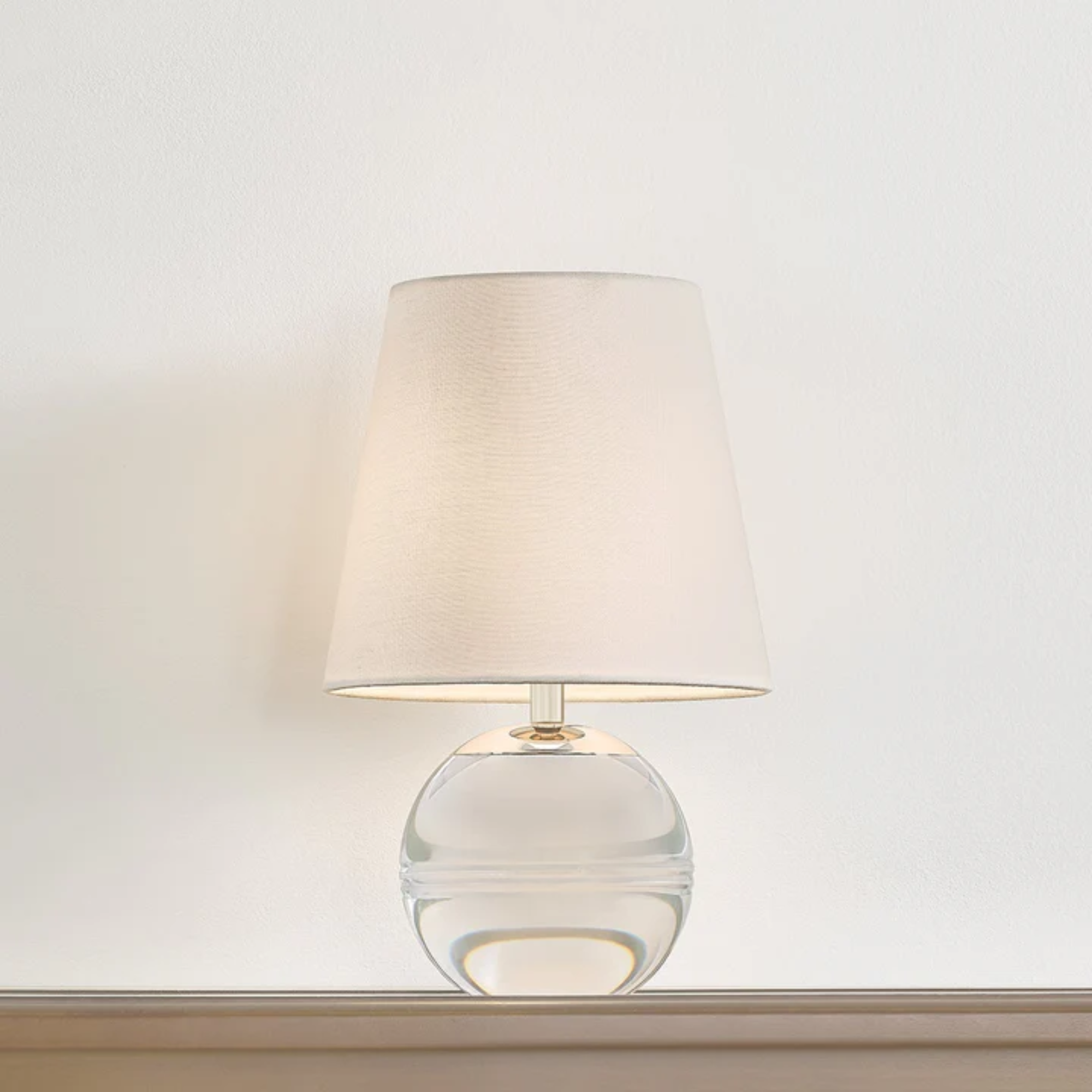 The Nicole Rechargeable LED Table Lamp from Mitzi in a studio on top of a surface.