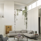 The black Ease Cordless Lamp from Muuto in a living area overlooking the sofa and other furniture.