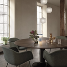 The light blue Ease Cordless Lamp from Muuto in a dining area on top of a dining table.
