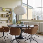 The light blue Ease Cordless Lamp from Muuto in a dining room on a windowsill.