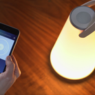 The Uma Sound Table Lamp from Pablo Designs, a bluetooth speaker being used by a phone.