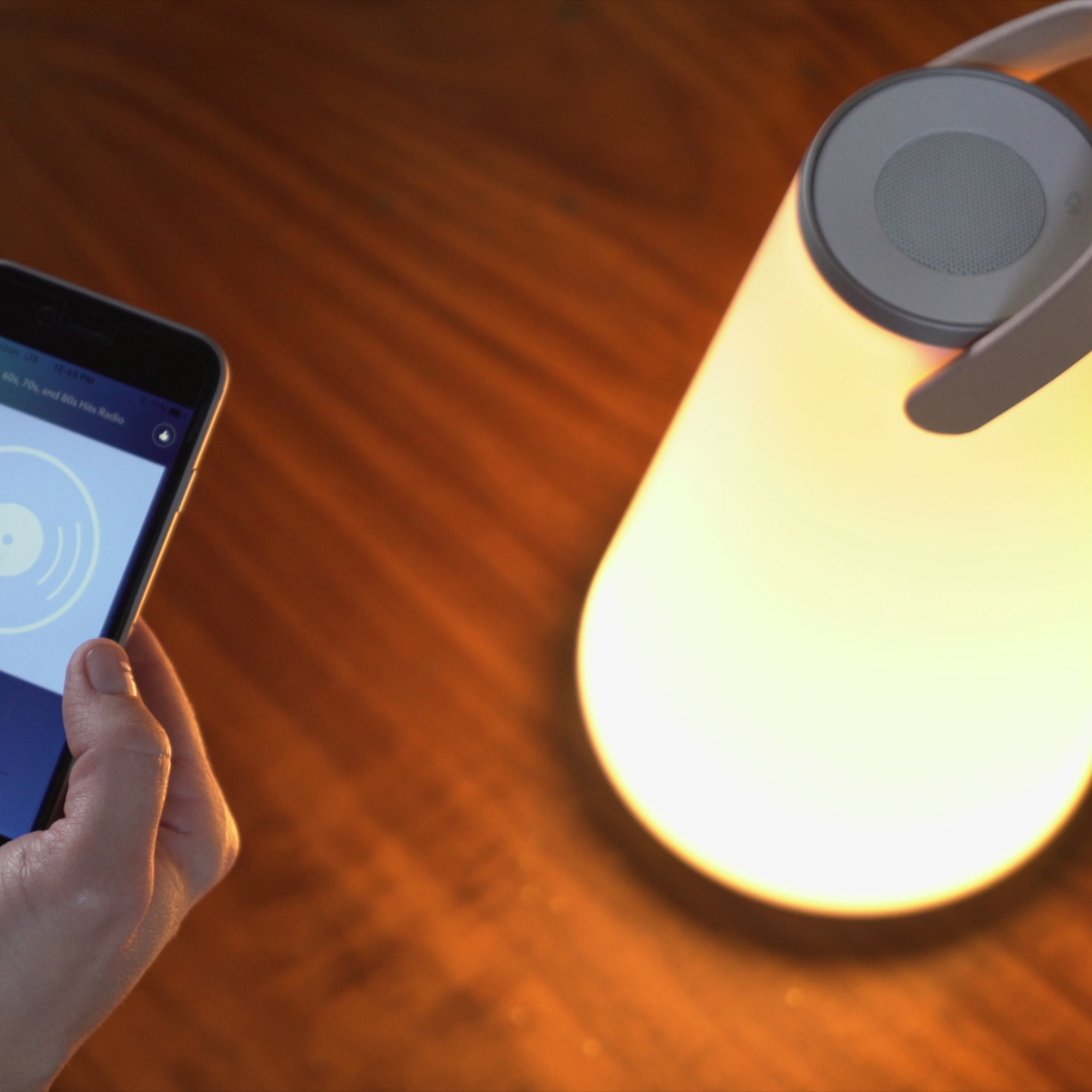 The Uma Sound Table Lamp from Pablo Designs, a bluetooth speaker being used by a phone.