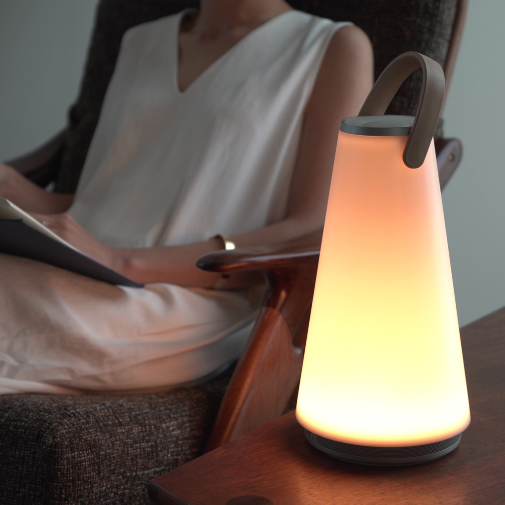The Uma Sound Table Lamp from Pablo Designs in a living room.