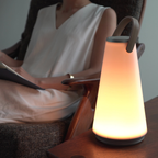 The Uma Sound Table Lamp from Pablo Designs in a living room.