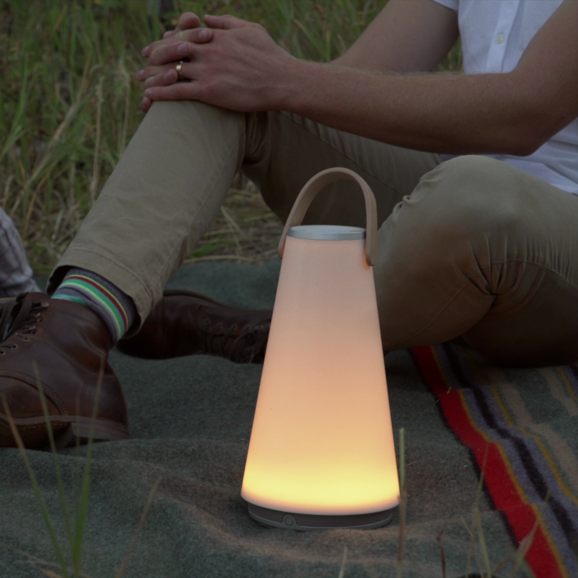 The Uma Sound Table Lamp from Pablo Designs in a meadow.