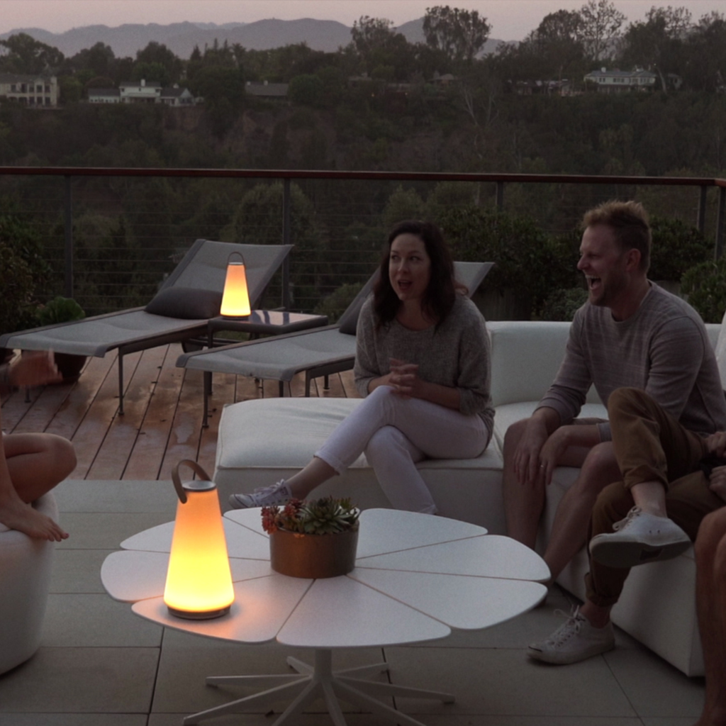 The Uma Sound Table Lamp from Pablo Designs in an outdoor living space.