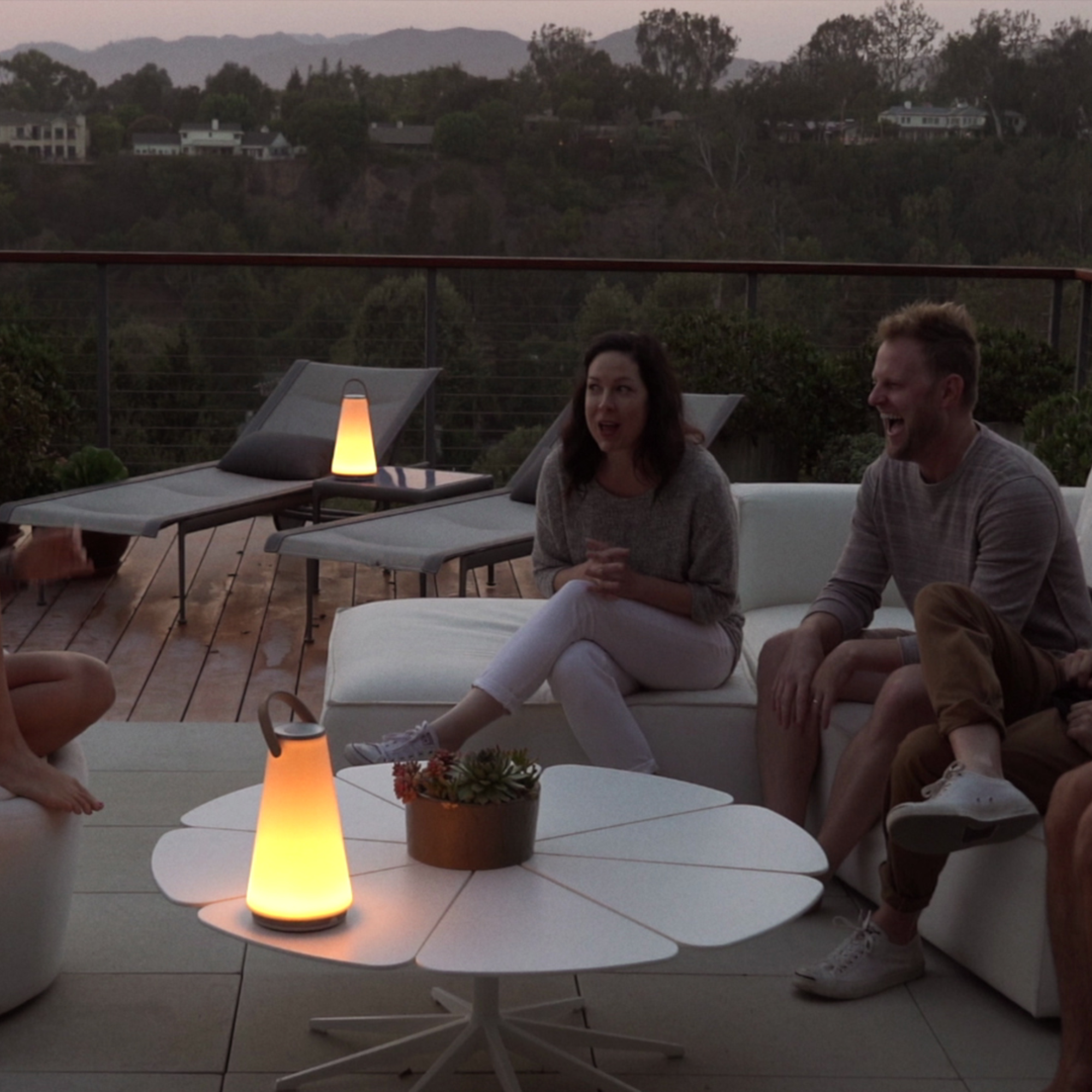 The Uma Sound Table Lamp from Pablo Designs in an outdoor living space.