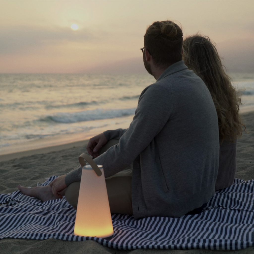 The Uma Sound Table Lamp from Pablo Designs used for a beach picnic.