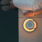 The Uma Sound Table Lamp from Pablo Designs beside a pool.
