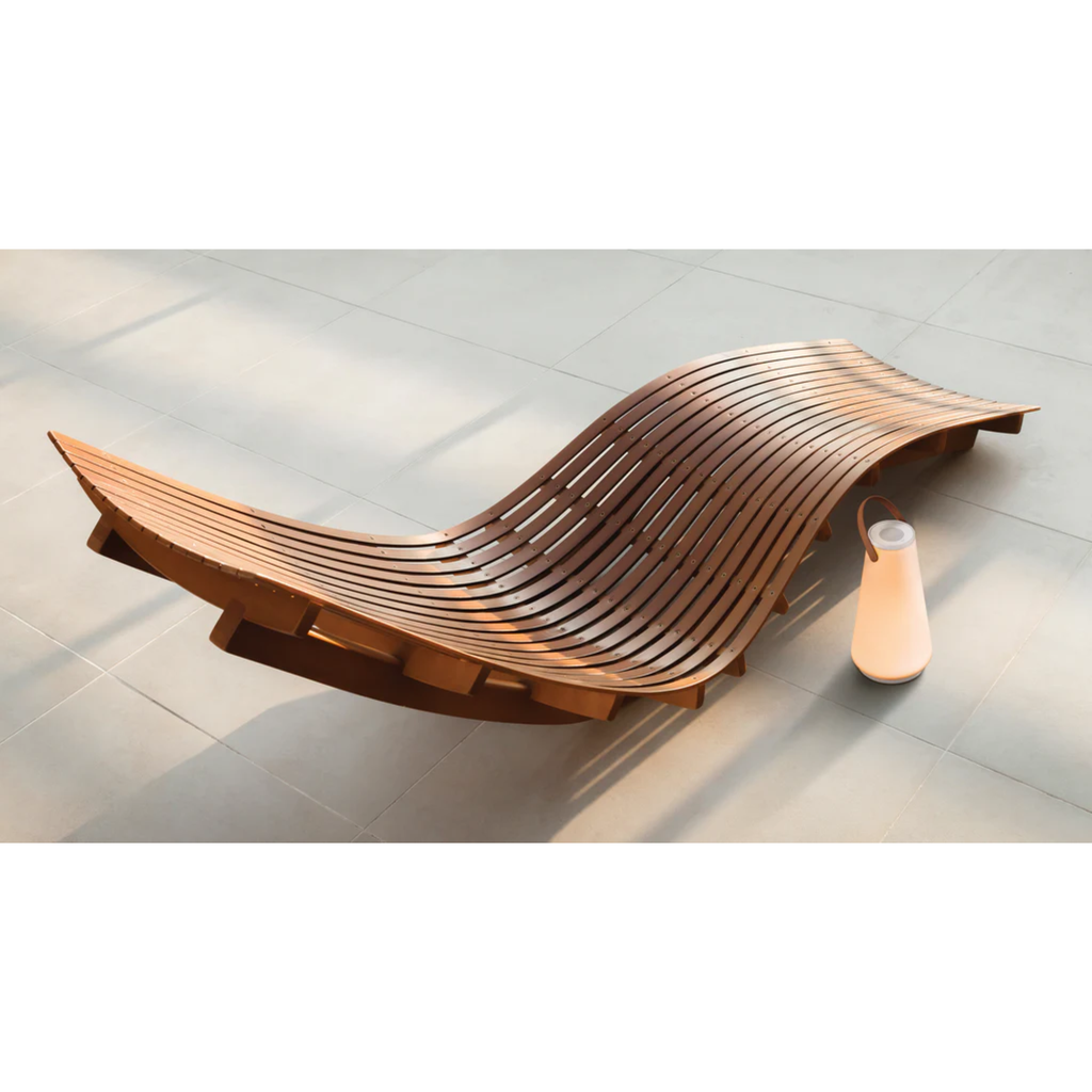 The Uma Sound Table Lamp from Pablo Designs beside a sunbed.