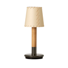 The Básica Mínima Batería Cordless Lamp from Santa & Cole with the stitched beige parchment shade.