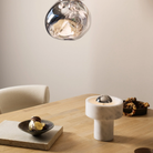 The silver Stone Cordless Lamp from Tom Dixon in a dining room on a dining room table.