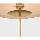The gild with cream linen shade with black linen trim Walker Cordless Floor Lamp from Visual Comfort Signature fixture showing the metal post and linen shade.