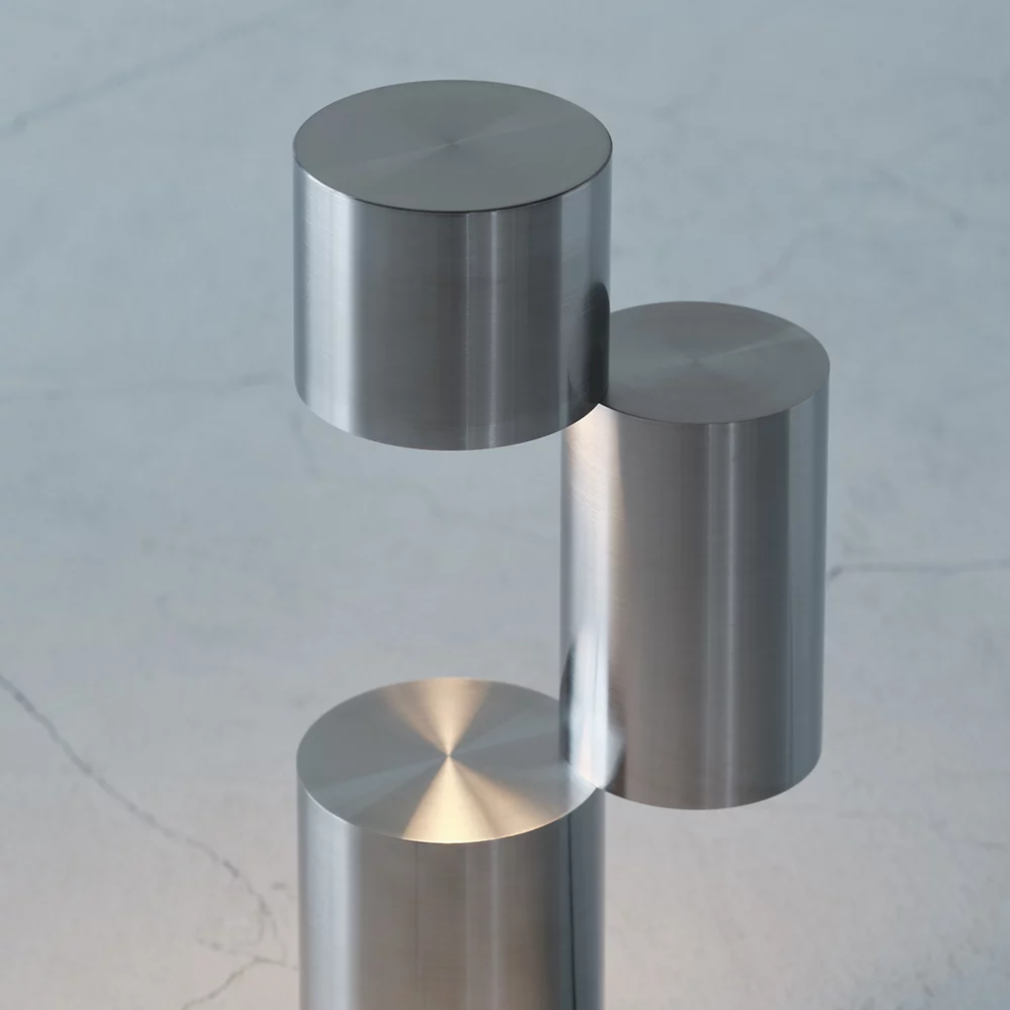 The MOMENT Cordless Lamp from Y.S.M, configuration three (3) in a living area, turned on, close up.