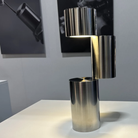 The MOMENT Cordless Lamp from Y.S.M, configuration three (3) in an art gallery with canvas' behind.