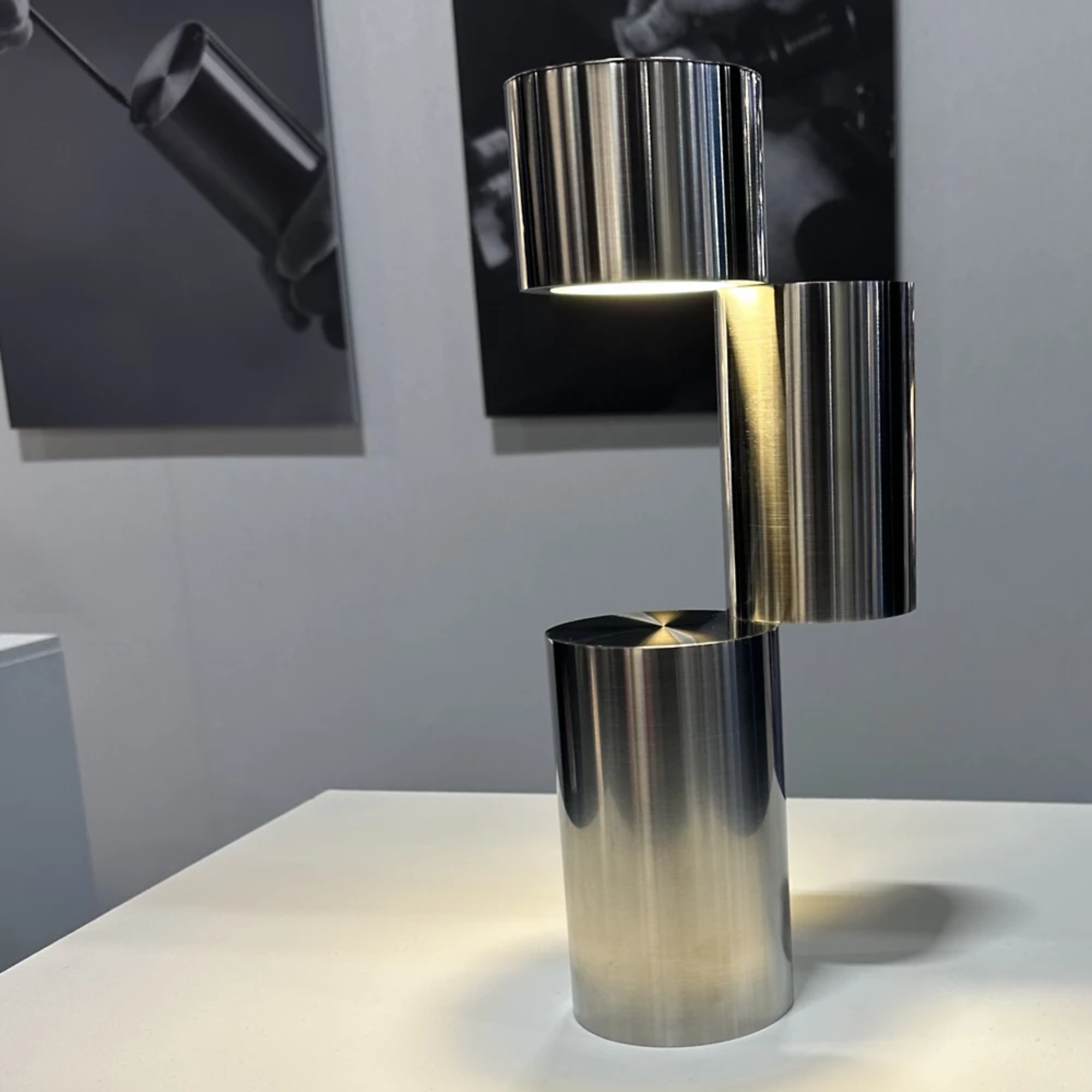 The MOMENT Cordless Lamp from Y.S.M, configuration three (3) in an art gallery with canvas' behind.
