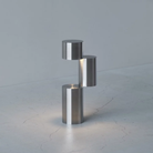 The MOMENT Cordless Lamp from Y.S.M, configuration three (3) in a living space on a stone surface.