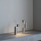 The MOMENT Cordless Lamp from Y.S.M in a living room showing two of the configurations on a stone surface. all-groups