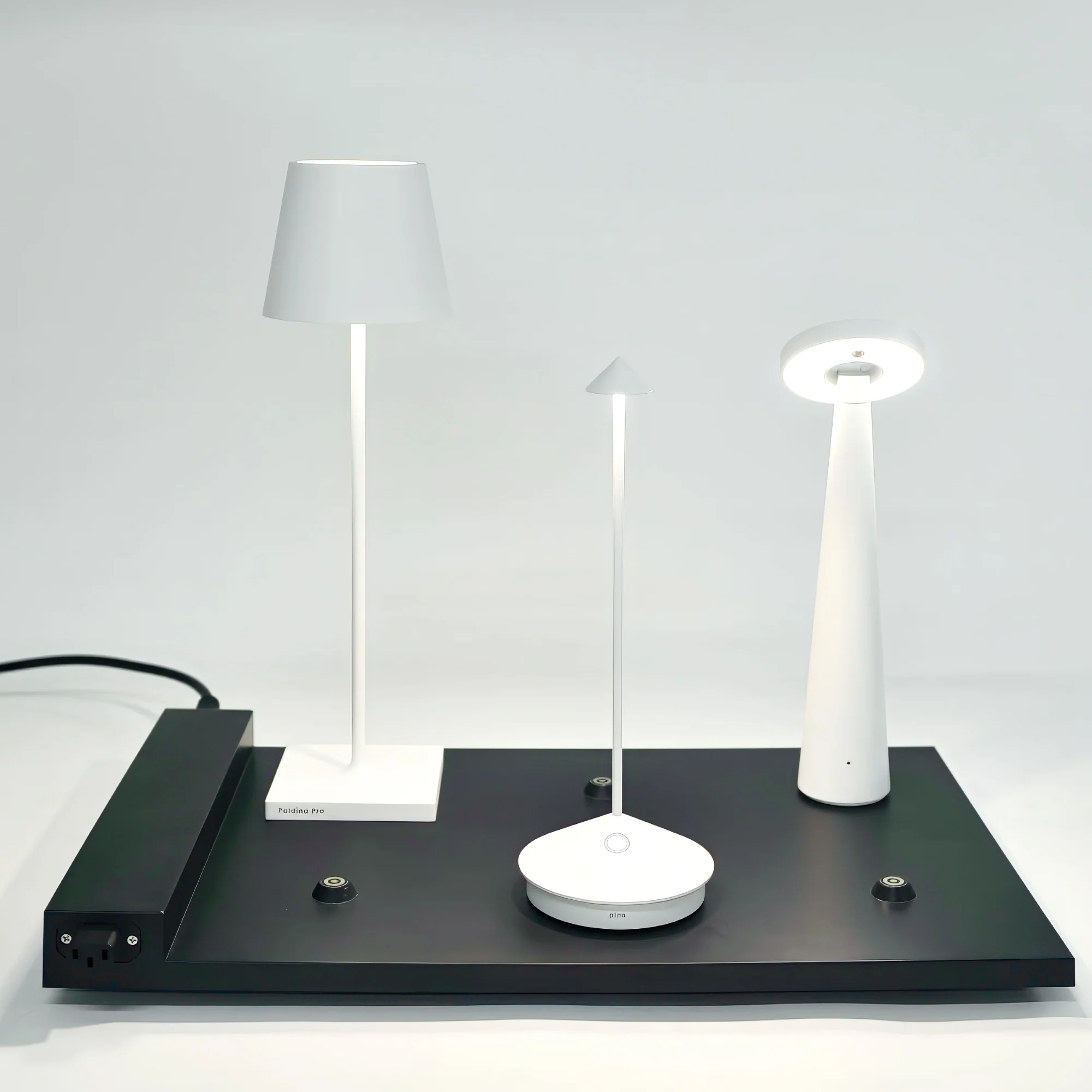 The black 6-Lamp Charging Platform - Pro Series from Zafferano used to charge a couple of cordless lamps.
