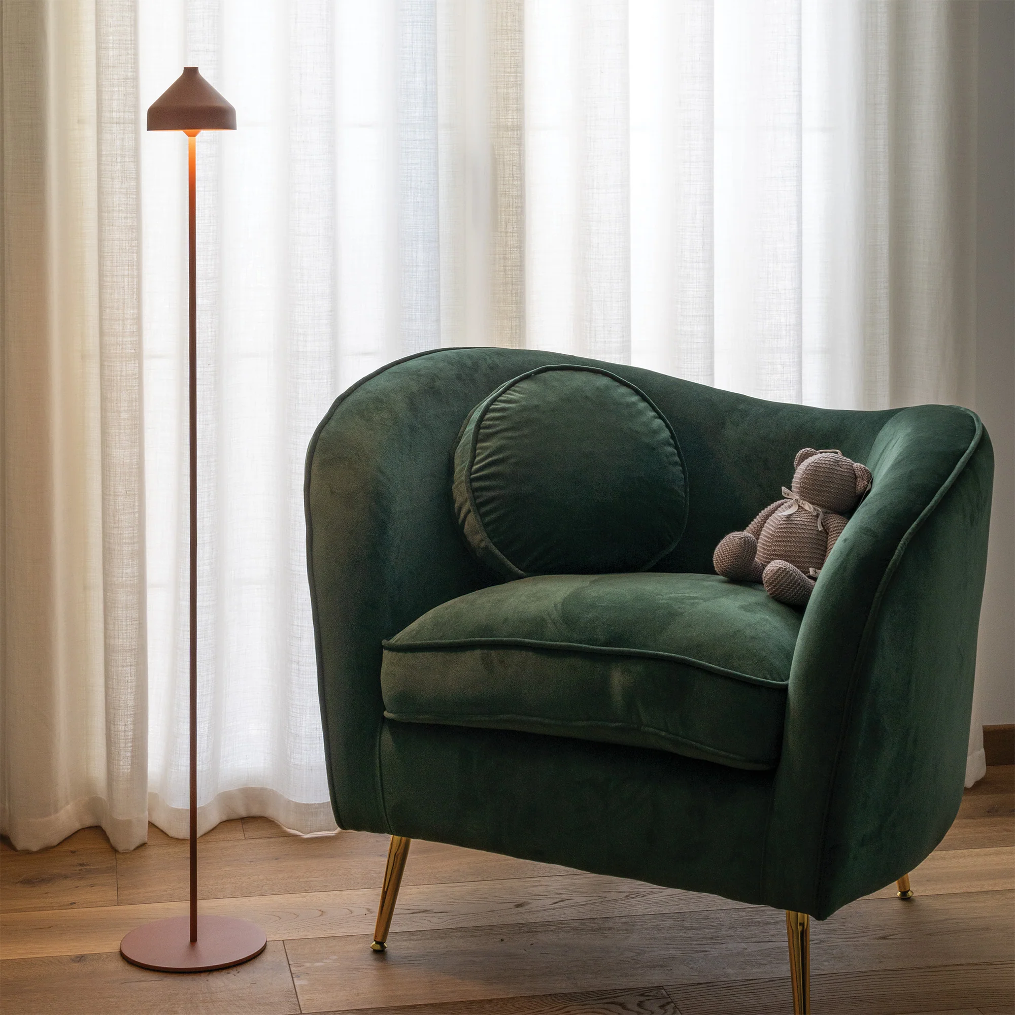 The terracotta Amelie Pro Cordless Floor Lamp from Zafferano in a lounge.