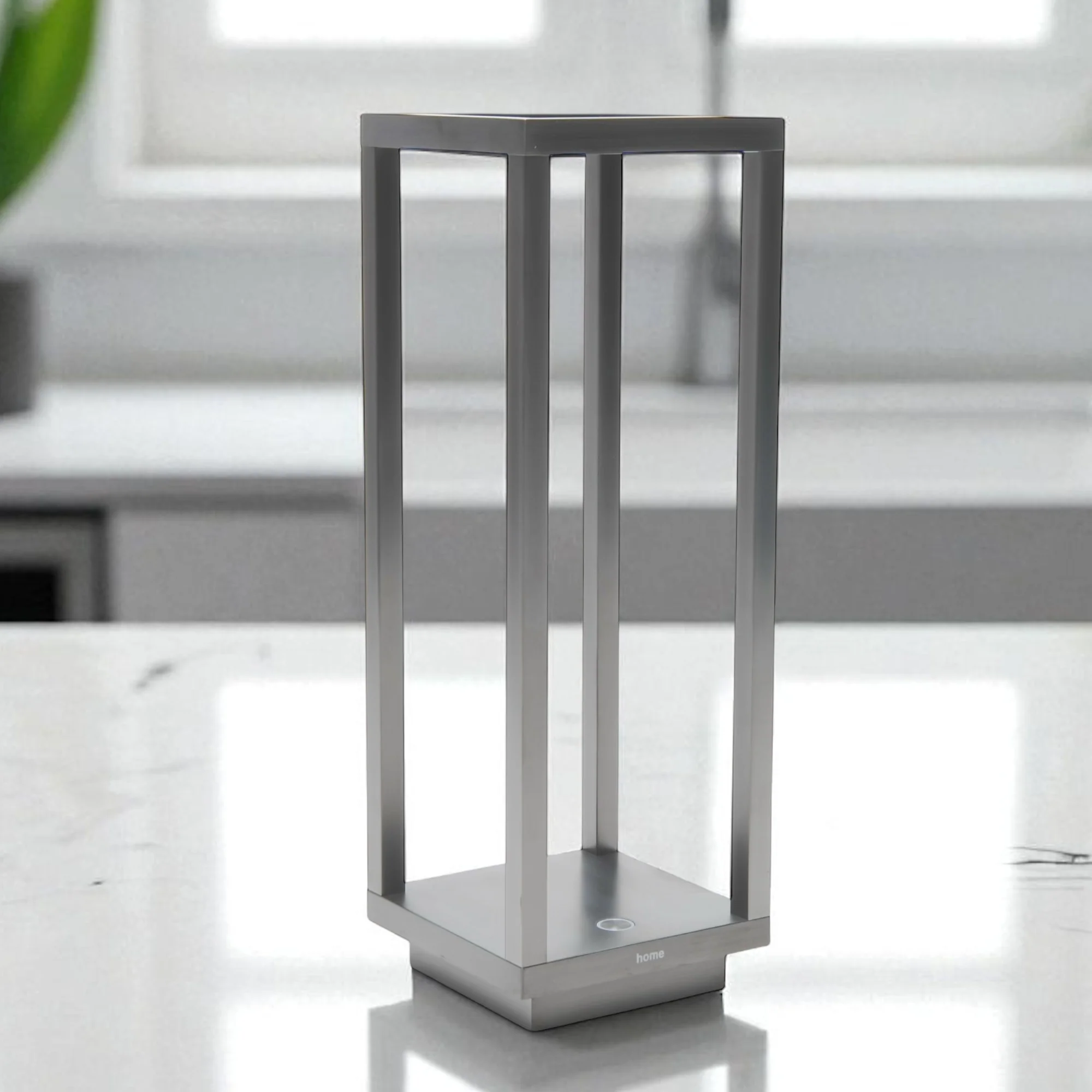 The antique nickel Home Cordless Lamp from Zafferano on a kitchen counter.