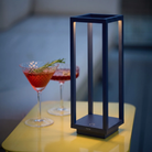 The steel blue Home Cordless Lamp from Zafferano in a living room.