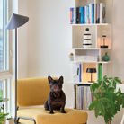 The titanium Pina XXL Cordless Floor Lamp from Zafferano in a lounge beside a lounge chair.