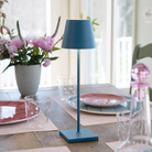 The avio blue Poldina Pro from Zafferano in a dining room on a dining room table.