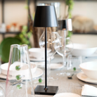 The black Poldina Pro from Zafferano in a restaurant on top of a dining table.