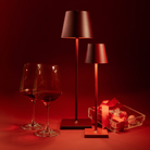 The bordeaux Poldina Pro from Zafferano in a living room with wine glasses and chocolates.