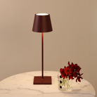 The bordeaux Poldina Pro from Zafferano in a lounge on top of a marble table.