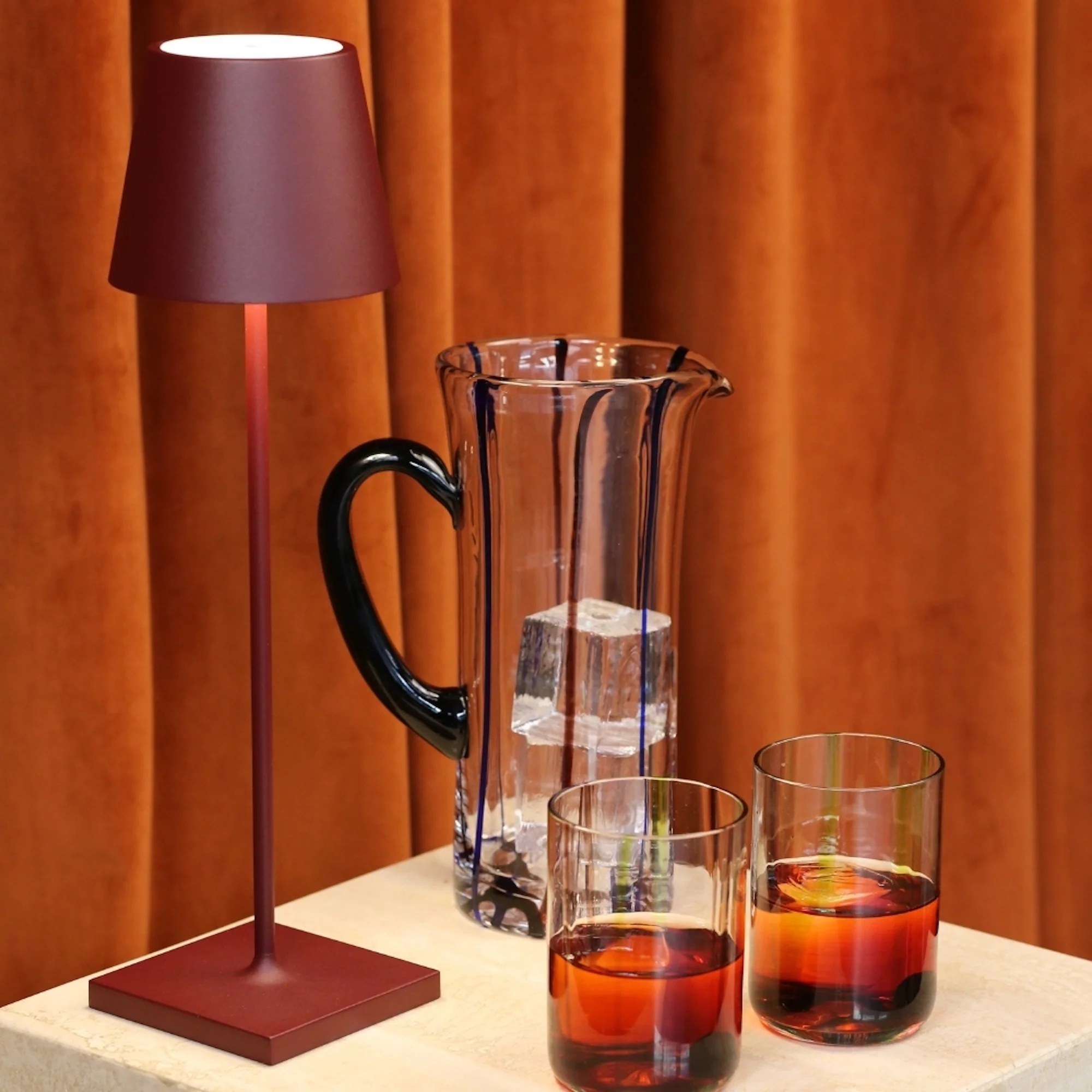 The bordeaux Poldina Pro from Zafferano used at a wet bar with a pitcher and drinks.