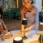 The dark green Poldina Pro from Zafferano used at a restaurant to illuminate a table.