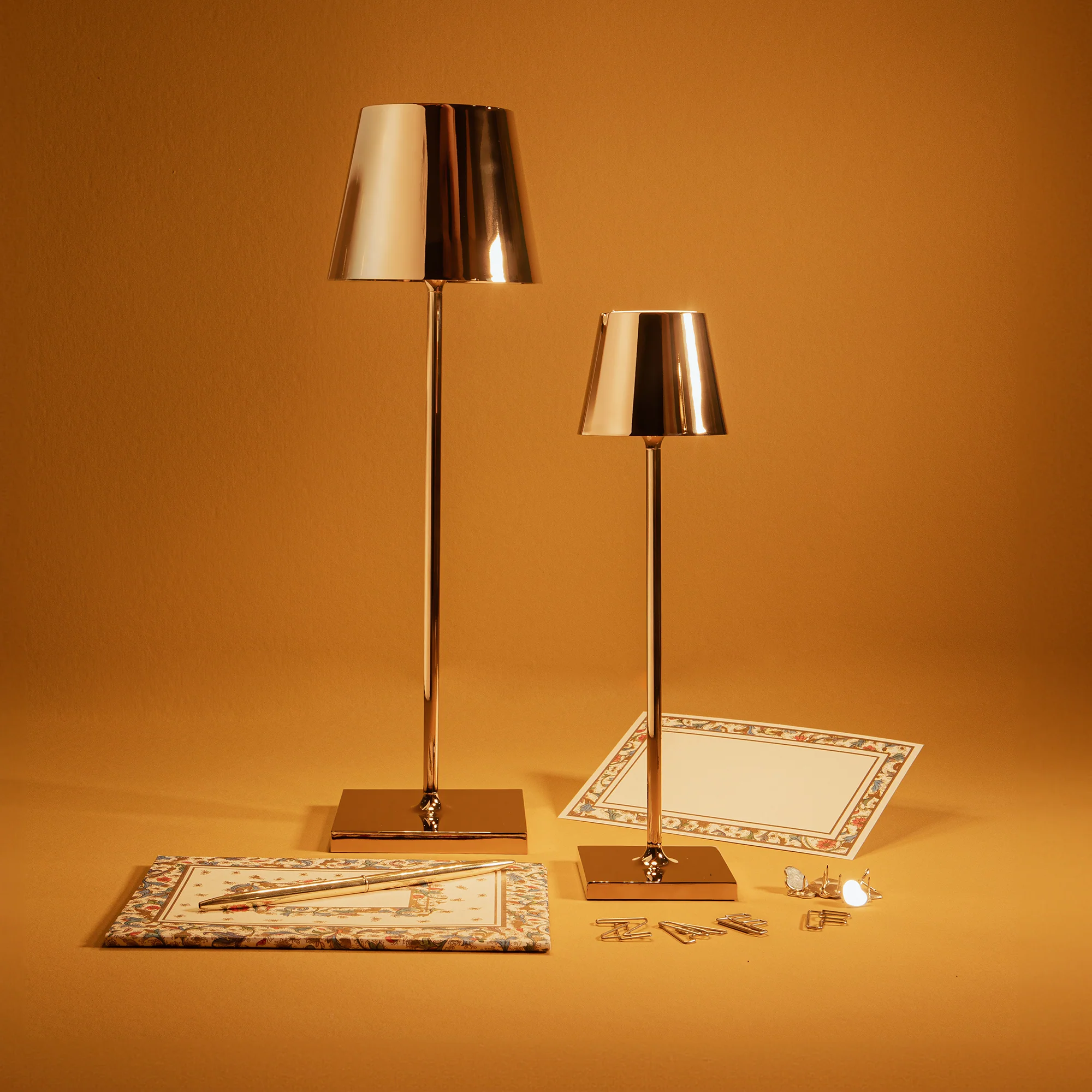 The glossy gold Poldina Pro from Zafferano in a living room with various gold decor.