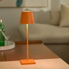 The orange Poldina Pro from Zafferano in a living room on top of a coffee table.