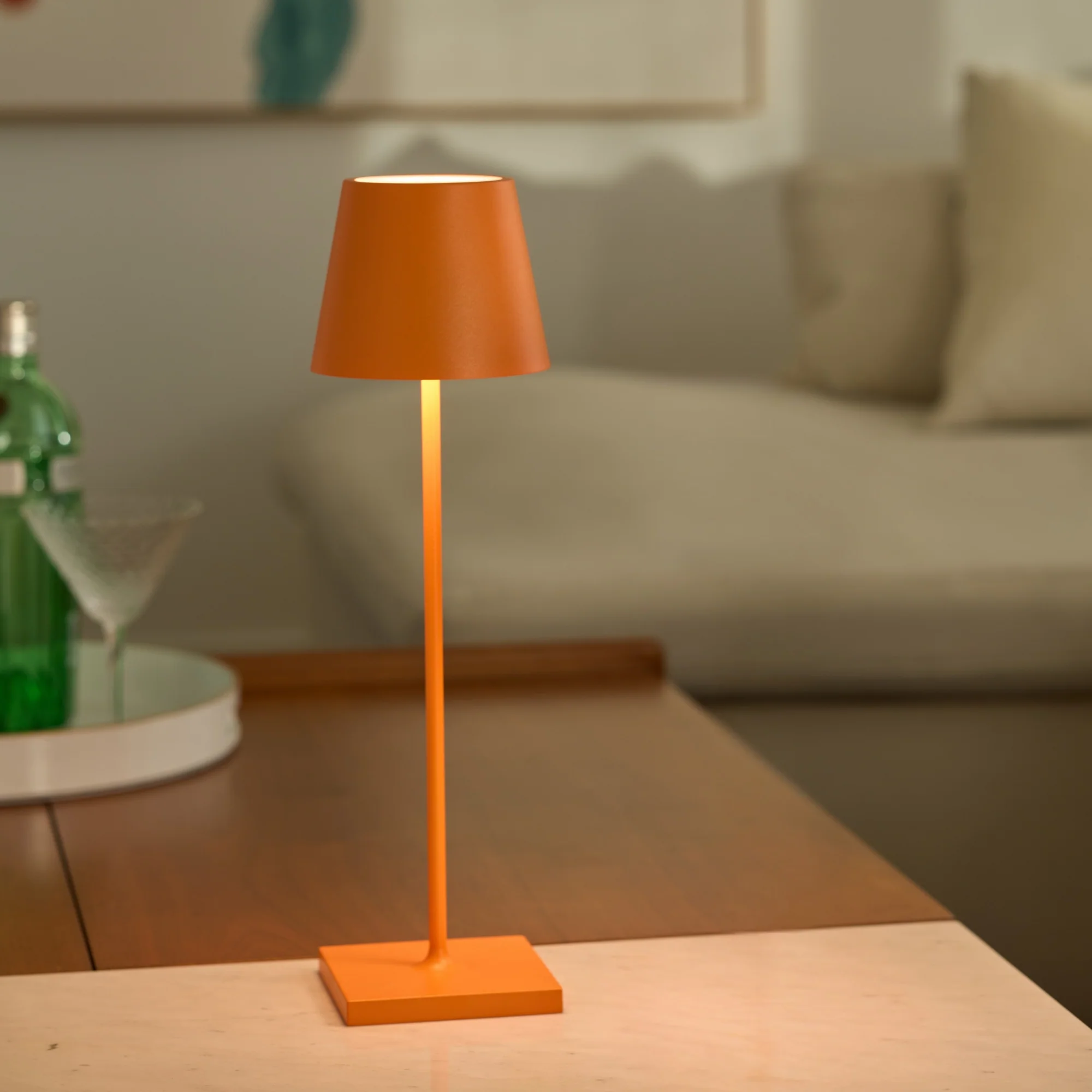 The orange Poldina Pro from Zafferano in a living room on top of a coffee table.