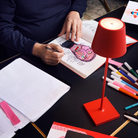 The red Poldina Pro from Zafferano in an art studio with an artist drawing.