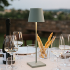 The sage Poldina Pro from Zafferano used in an outdoor dining setting on top of a table overlooking a valley.