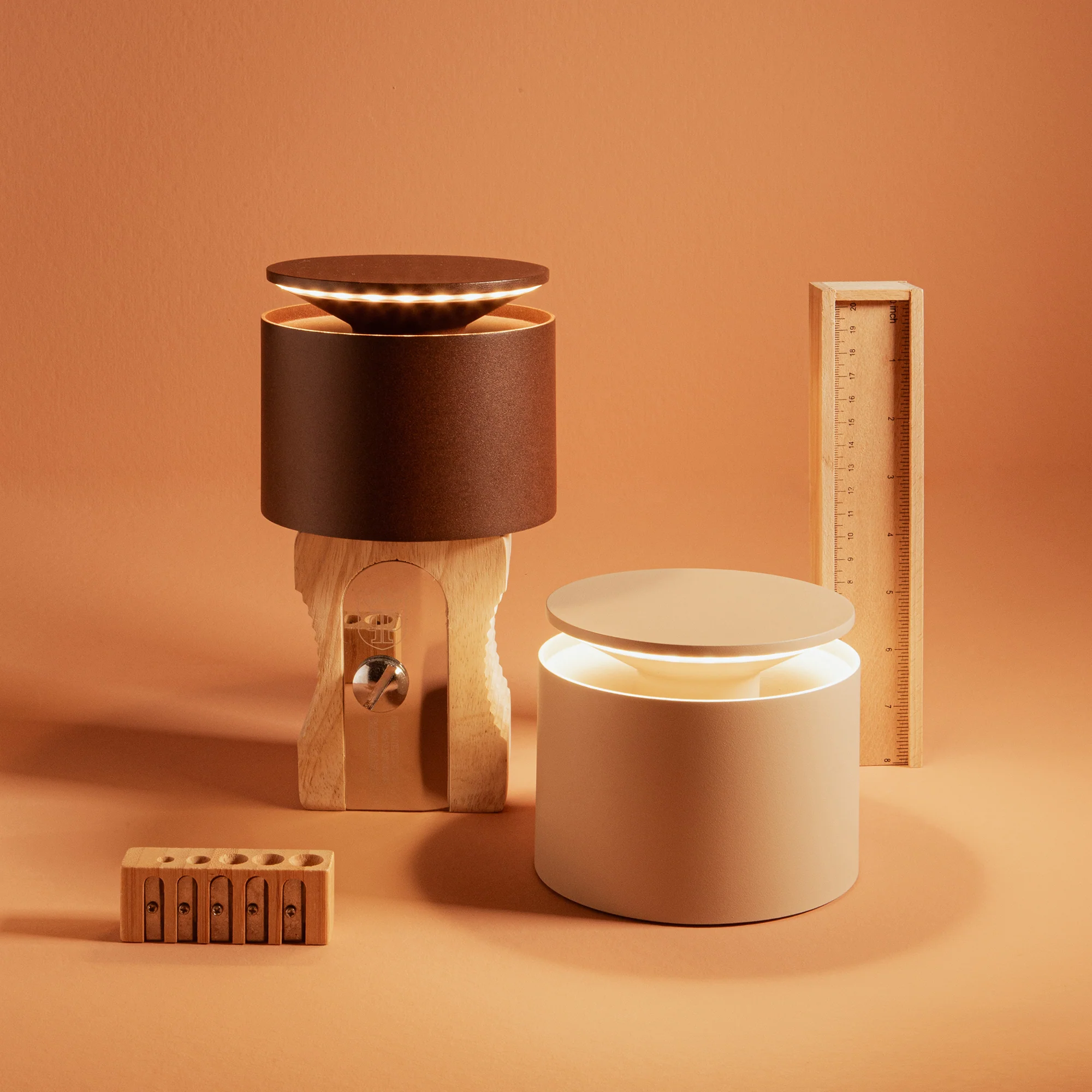 The rust PushUp Pro Cordless Lamp from Zafferano in a studio with another PushUp Pro portable light.