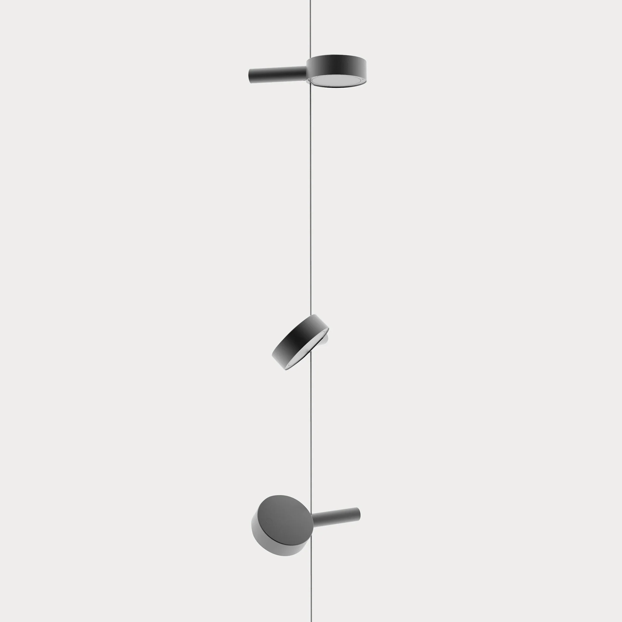 The black Super O Suspended Cordless Floor Lamp from Zafferano with 3 lights in a studio.