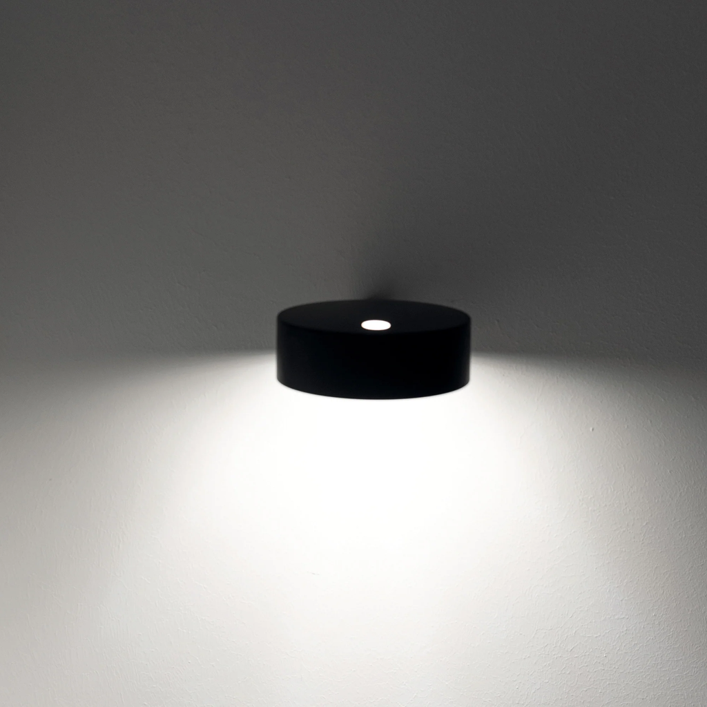The black Super O Wall Spotlight Sconce from Zafferano in a family space.