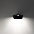 The black Super O Wall Spotlight Sconce from Zafferano in a family space.